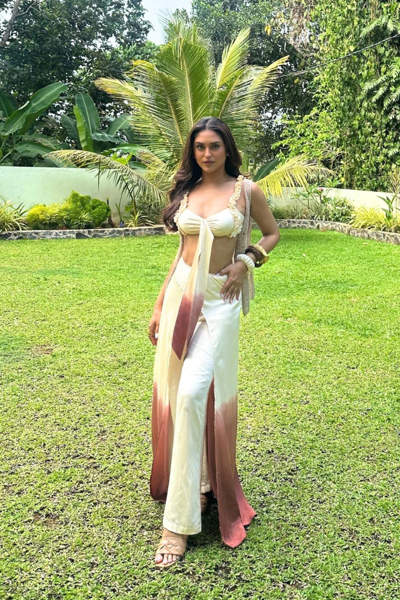Worn by Krystle D' Souza, Sand ombre satin co-ord set for women — beige to brown flared pants and tie-up top — Label WildChild India